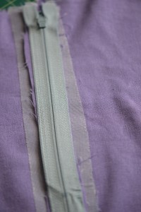 Place the zipper right side down on the seam alowances